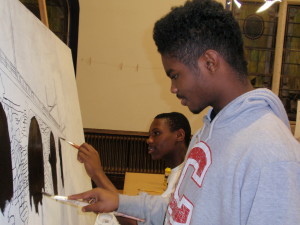 Dondre Pittman (left), 15, and Nasir Newton, 15, work on the image of Coatesville's railroad bridge.