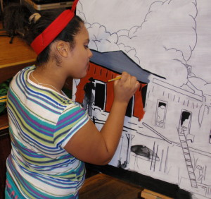 Amanda Gayton, 15, works on a section of the mural depicted the arsons that terrorized Coatesville.