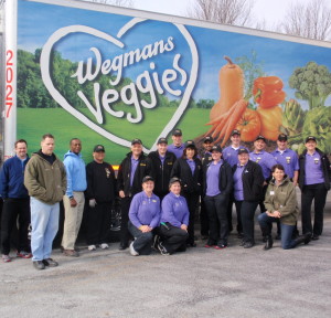 Wegmans employees pose with workers at the Chester County Food Bank outside the loading dock.