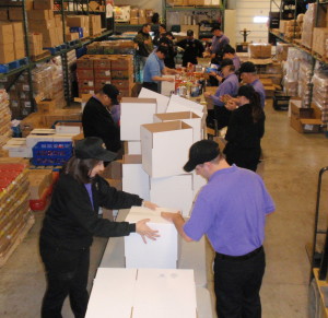 A high-energy crew of Wegmans employees formed an assembly line inside the warehouse of the Chester County Food Bank, where they sorted the donation of 18,000 pounds of food.