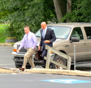 Accompanied by his attorney, Daniel Bush (right), Gerald D. Pawling, a former Coatesville detective, arrives at Caln district court for his arraignment on theft charges.