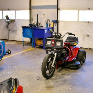 One of many student projects sits in the Learning Center small engines shop. Students fused an obsolete tractor with an obsolete motorcycle to make a working hybrid.