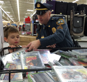 Sgt. Rodger Ollis helps his shopper with a DVD selection.