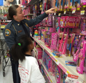 Coatesville Det. Shannon Smith offers assistance to her shopper in the Barbie section.