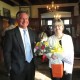 Lindsay Brinton (right), founding and outgoing director of Art Partners Studio, receives congratulations on her retirement from Jim Zeigler, a former board member.