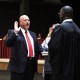 Dean Snyder is sworn into school board position by Judge Gregory Hines.