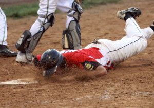 Seabees Josh Martin dives into home for the final run of the tilt in a 12-2 win.
