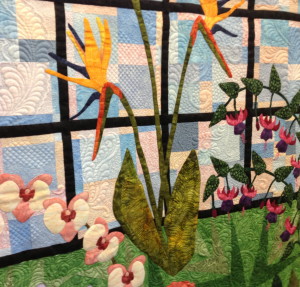 A detail from the three-paneled, light-themed quilt shows the garden’s bird of paradise flowers.
