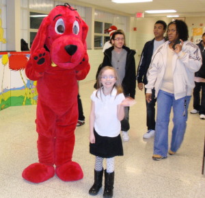 Seven-year-old Faith Munn, a student at King's Elementary, poses with Clifford, the big red dog.