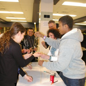 Attendees construct a tower out of spaghetti with a marshmallow on top. The exercise was meant to reflect the challenge of working together to improve the community.