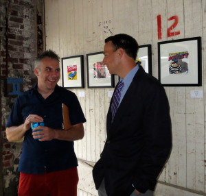 Artist Jeff Schaller (left) discusses his paintings with Chester County Commissioners' Chairman Ryan Costello. Schaller said he enjoyed placing his artwork on walls that boasted their own adornments, such as the number 12.