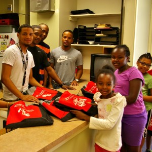 Students collect backpacks from Saturday's backpack drive at the Community Center.