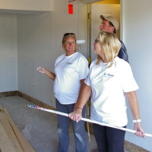First Niagara employees Susan Hernandez and Lindsay Schaub discuss how to paint a ceiling without dripping. Wednesday was Schaub's first time painting a ceiling.