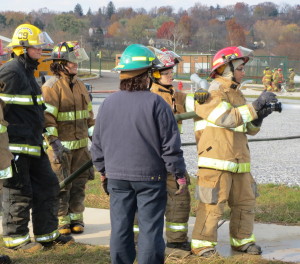 Mo Lahloui (right), 17, of Parkesburg, takes his turn getting used to the force of the nozzle as instructor Reenie McCormick (blue jacket) looks on.