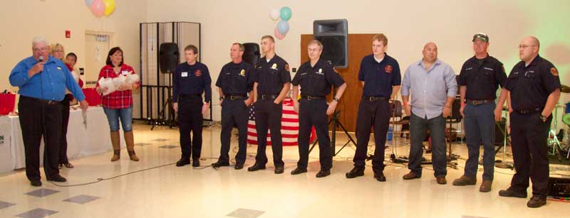 Master of Ceremonies Del Bittle (left) honors the Po-Mar-Lin Fire Company, during the ceremony.