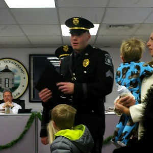 Sgt. Steve Parkinson stands in front of the Board of Commissioners meeting to receive the Chief's Letter of Commendation.