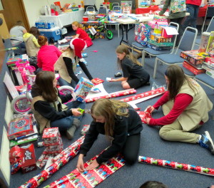 Girl Scouts from Troop 413265 and 4290 demonstrate their gift-wrapping prowess for the West Caln "Toys for Tots" campaign. 