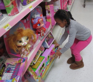 A toy conveniently placed where a 4-year-old can find it catches the eye of one of Saturday's shoppers.