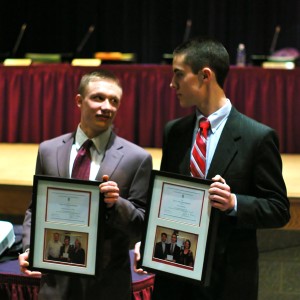 Chasan Hall (left) and Paul Draper (right) hold up their certificates for being recognized by the National Merit Scholar Program.