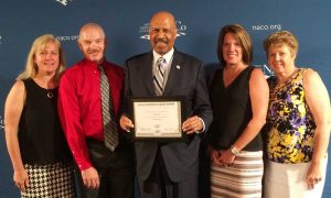 Representatives from the Chester County Intermediate Unit (CCIU) joined Chester County Commissioners’ Chair Terence Farrell in accepting the National Association of Counties (NACo) Achievement Award for Employment and Training at NACo’s annual conference in Long Beach, California.   Pictured from left to right are:  Dr. Jacalyn Auris and Mr. R. Scot Semple from the CCIU, County Commissioner Terence Farrell, and Laurie Masino and Dr. Anita Riccio, also from the CCIU.   